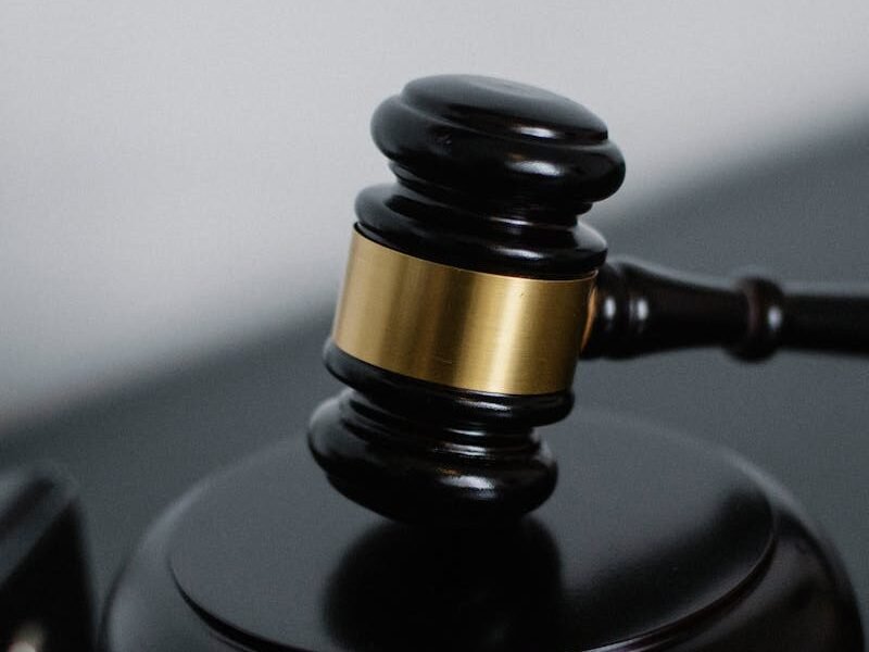 Close-up of a wooden gavel on a desk, symbolizing justice and legal authority.